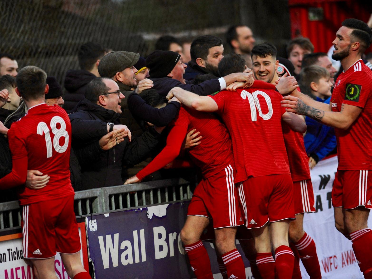 Worthing players celebrate the opening goal