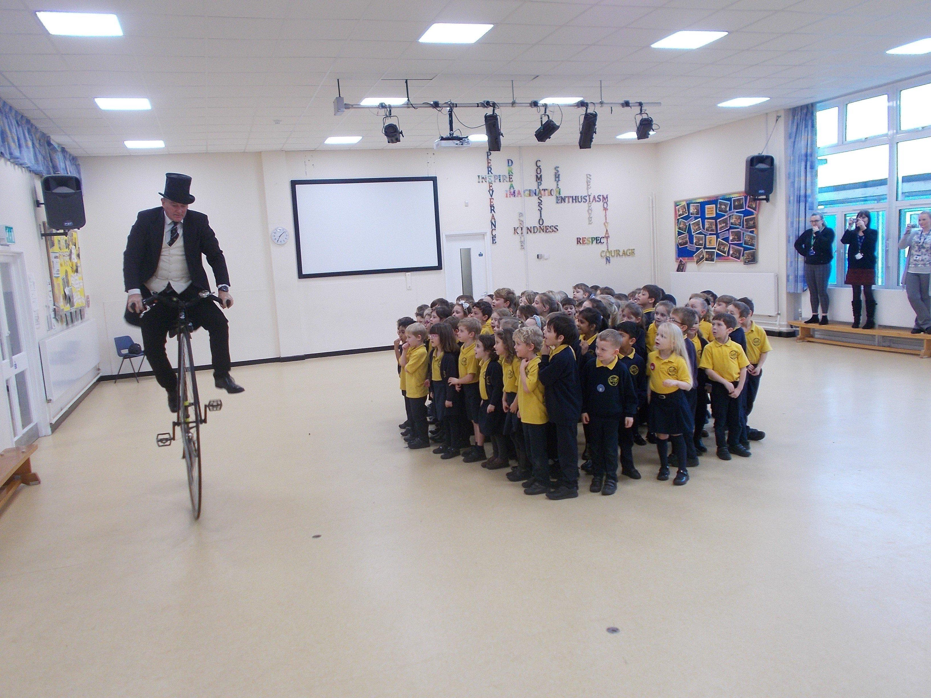 Secretary of the Penny Farthing Club, Neil Laughton, visited Upper Beeding Primary School with his penny farthing bicycle SUS-200129-103732001