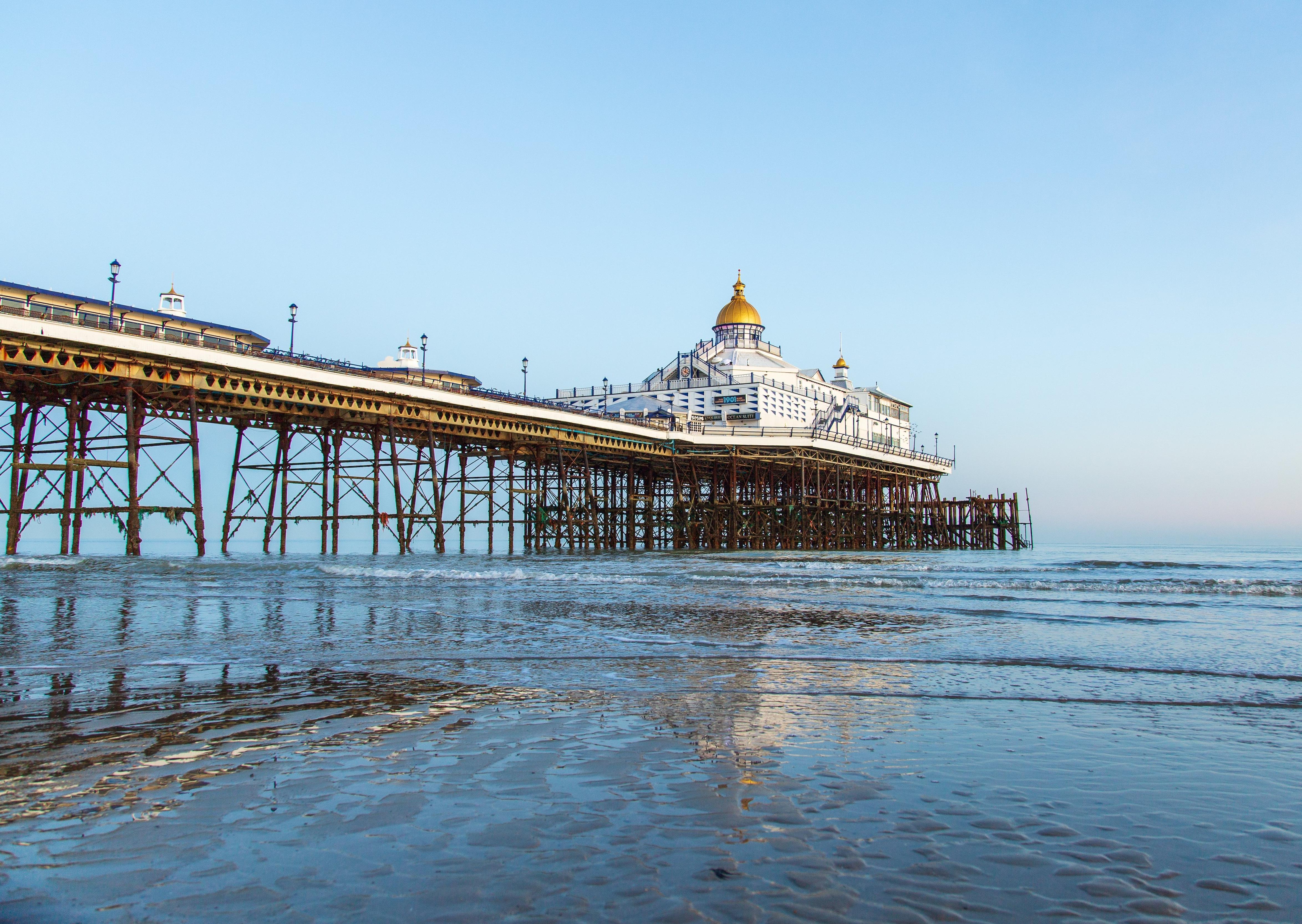 Eastbourne pier, at very low tide and all lit up by winter sunshine. This photograph was taken by Barry Davis, using a  Canon 5d iii SUS-200130-093640001