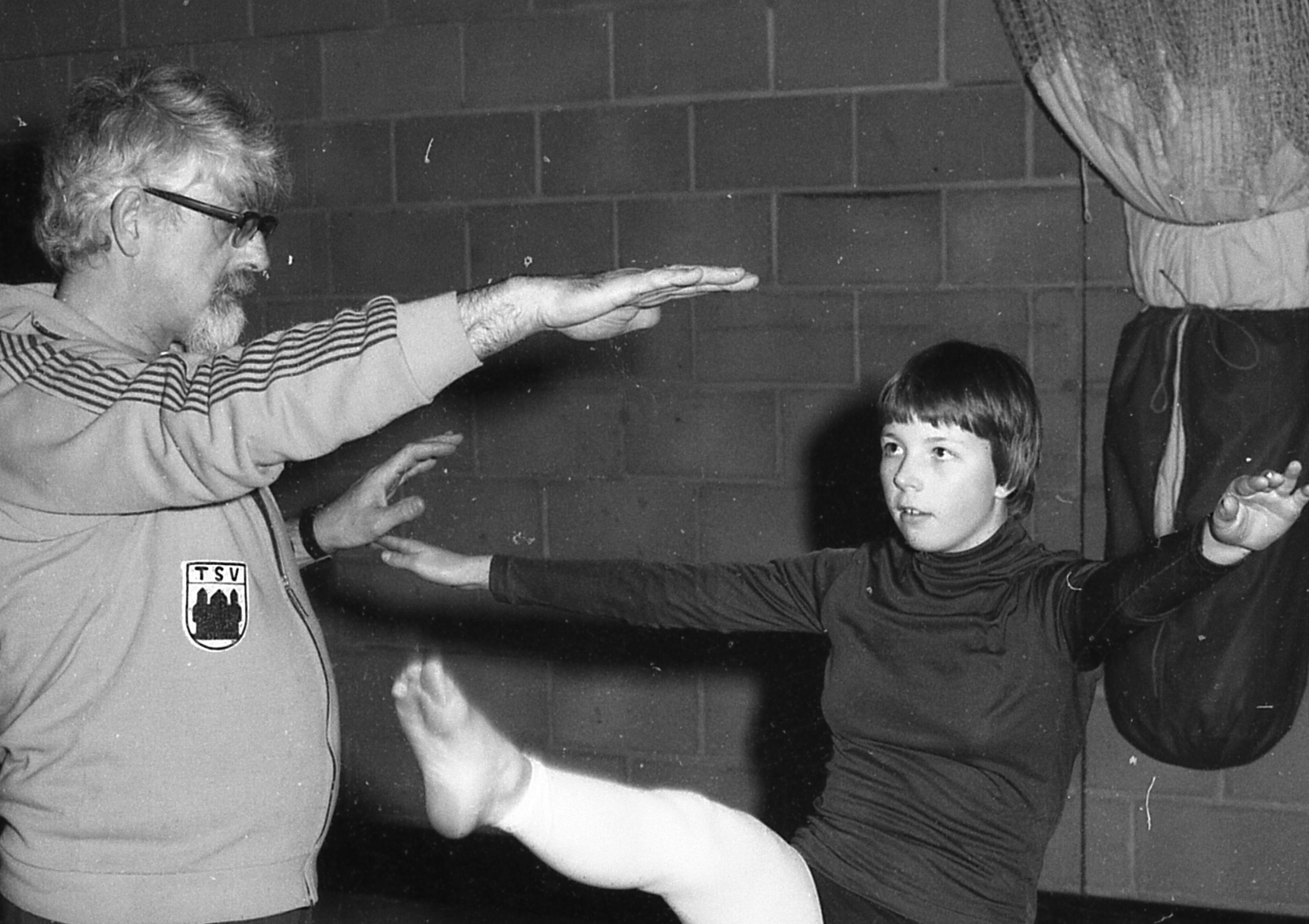 Tina French tries a few high kicks, helped by coach Roger Campling.