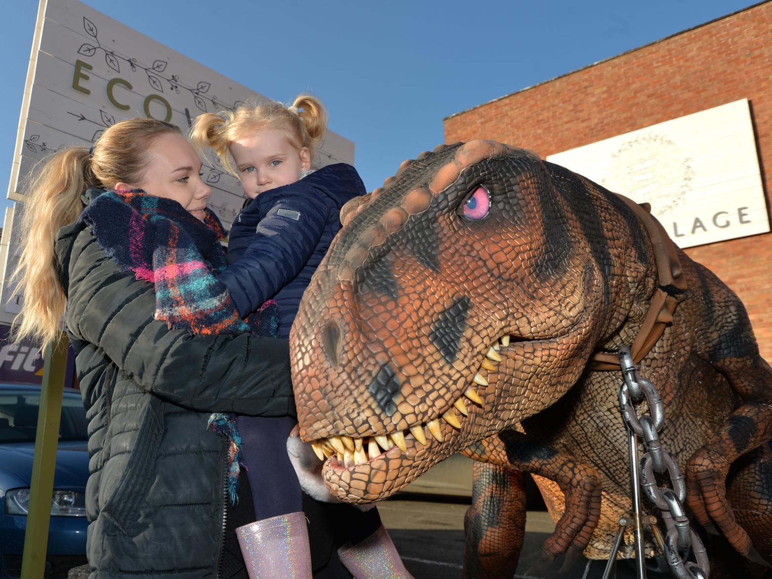 Lianne Parker and daugther Florance 3 meet a dinosaur during the opening of the Eco Village on St Mary's Road.