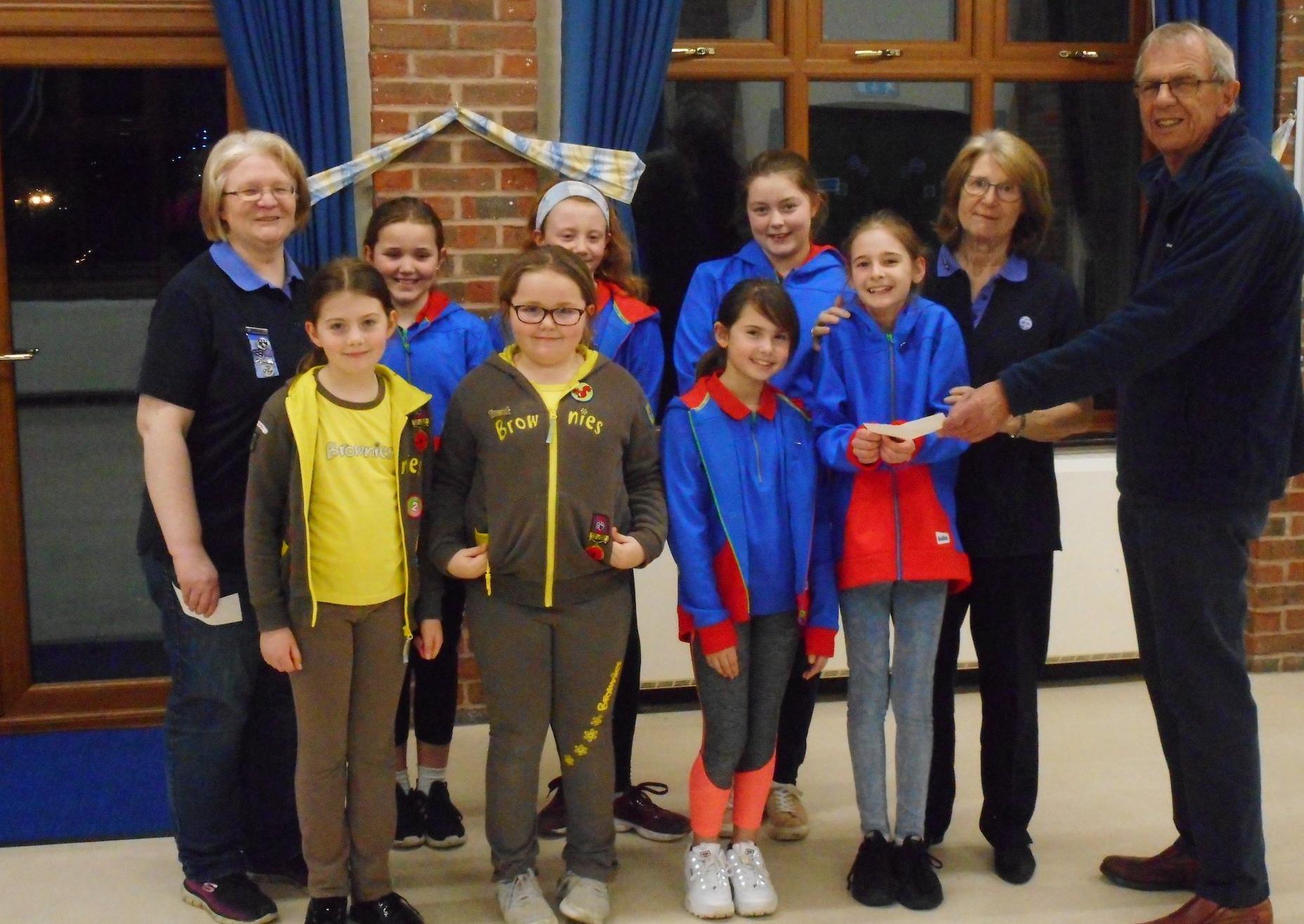 2nd Storrington Guides receiving a cheque for £500 from Rotarian Tony Vaughan SUS-201202-114646001