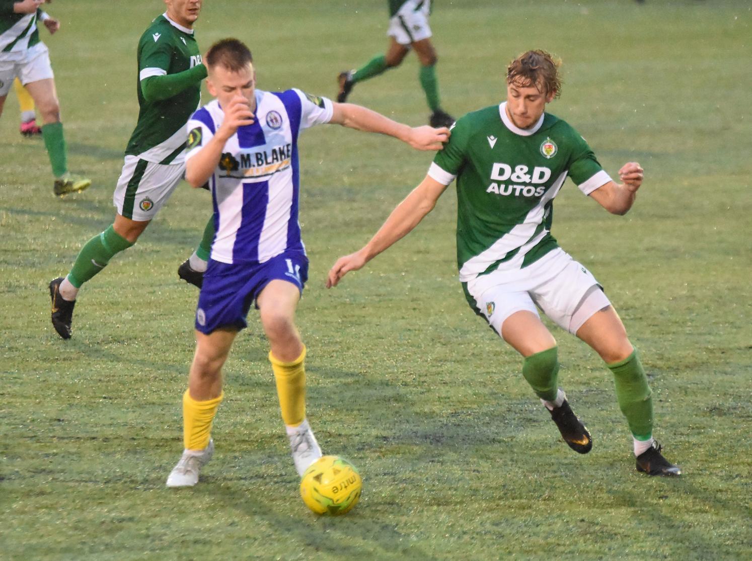 Keiran Rowe pokes the ball away from a defender
