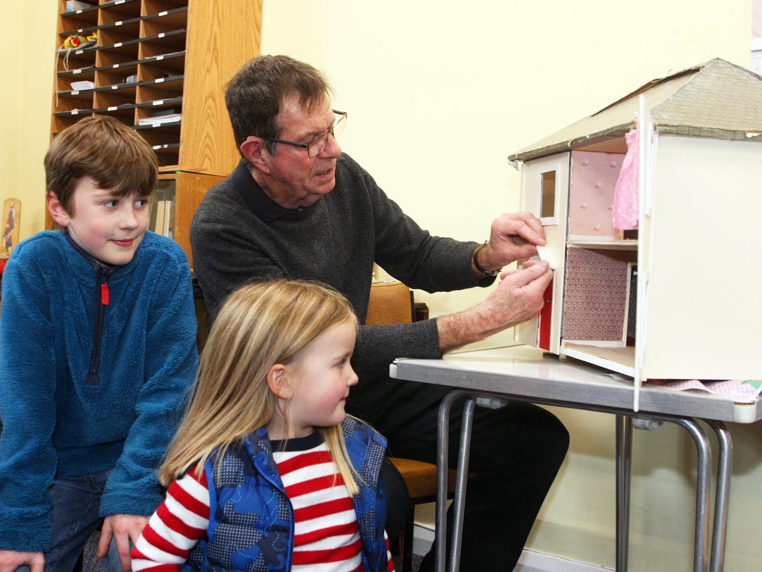 Simon Brown, James King (9) and sister Sophie (5) with their dolls house.