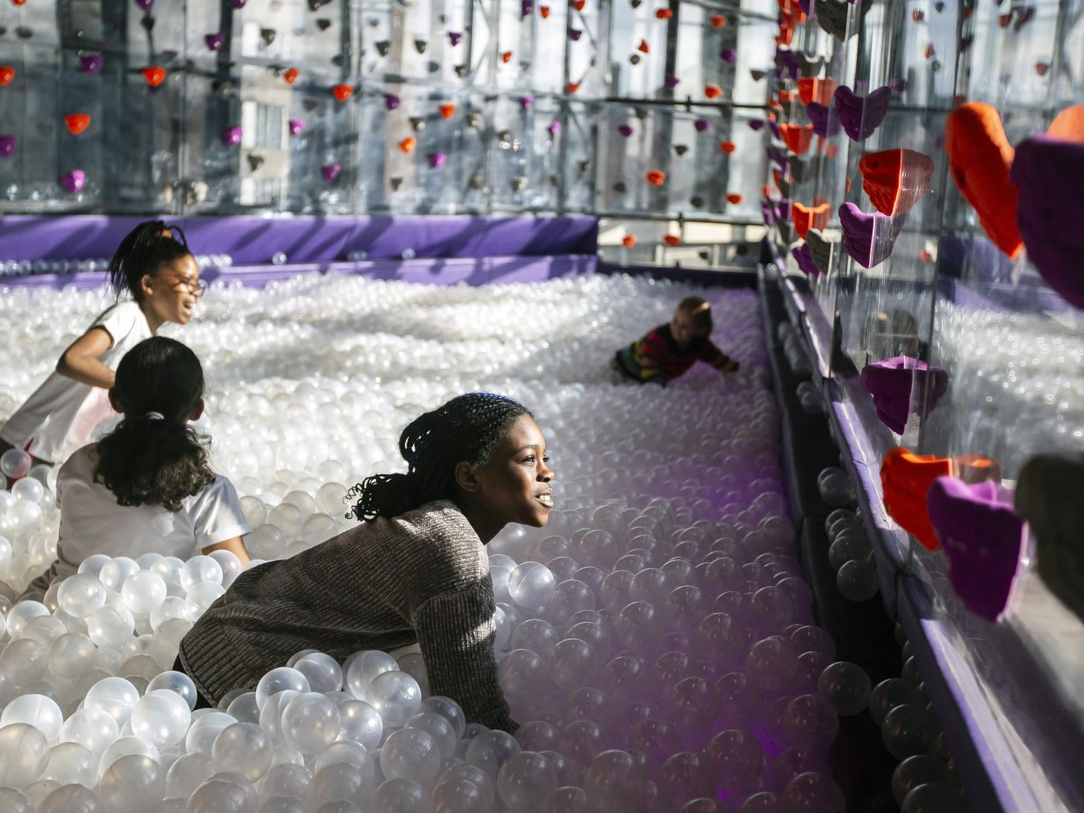 Kids enjoy the huge ball pit at Gravity in Sol Central
