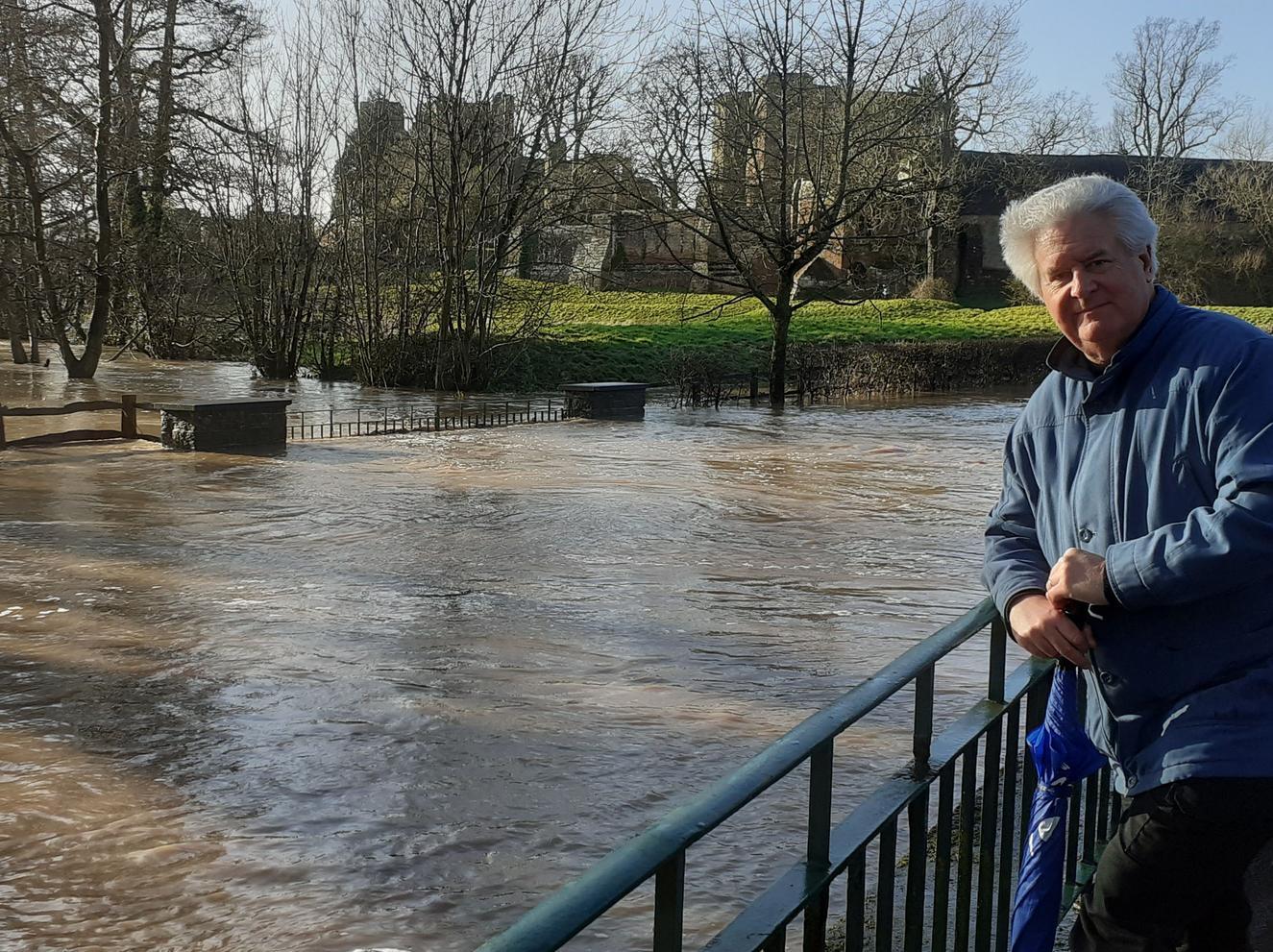 Mark Taylor stands in front of the flooded ford with Kenilworth Castle in the background (photo by Helen Taylor)