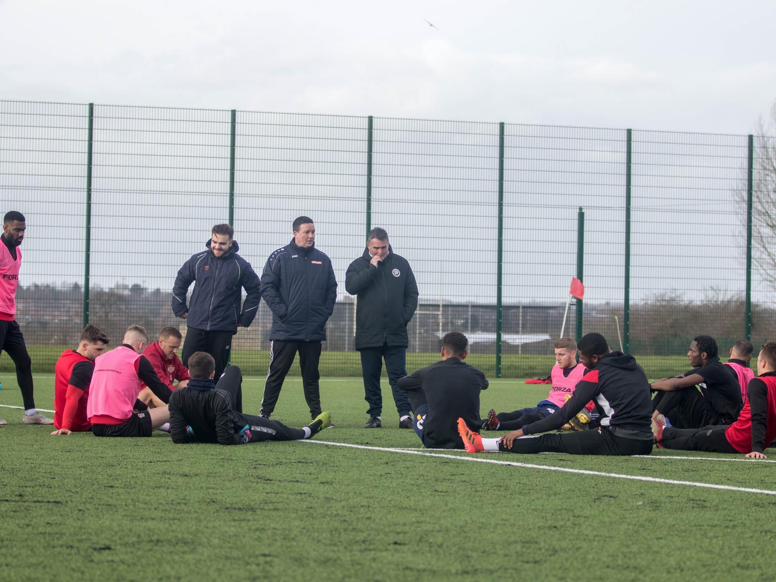 Paul Cox and his staff address the Kettering squad at training on Saturday