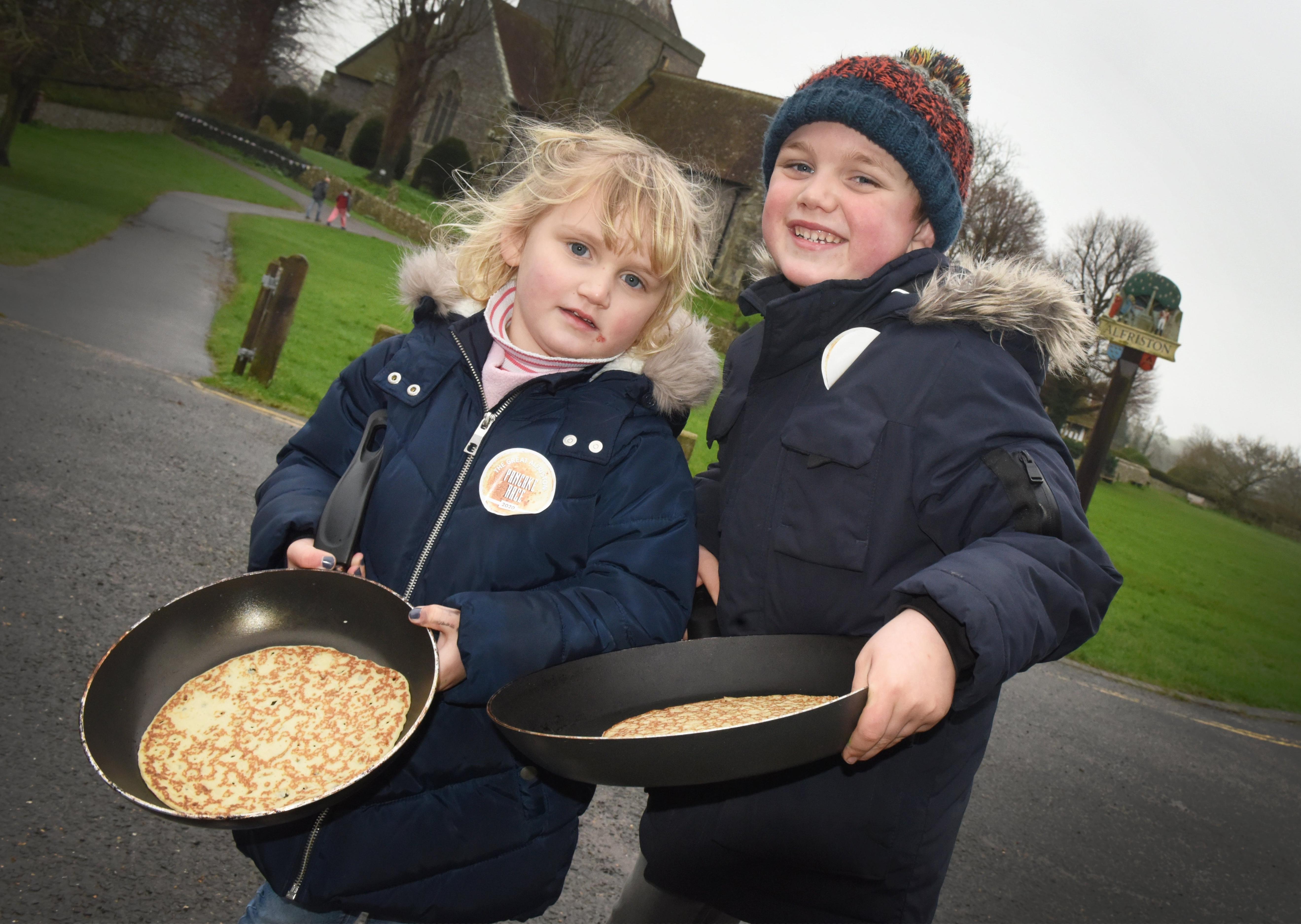 Matilda and Jack Sumners at the first Great Alfriston Pancake Race. Photograph: Justin Lycett/ SUS-200223-141839001