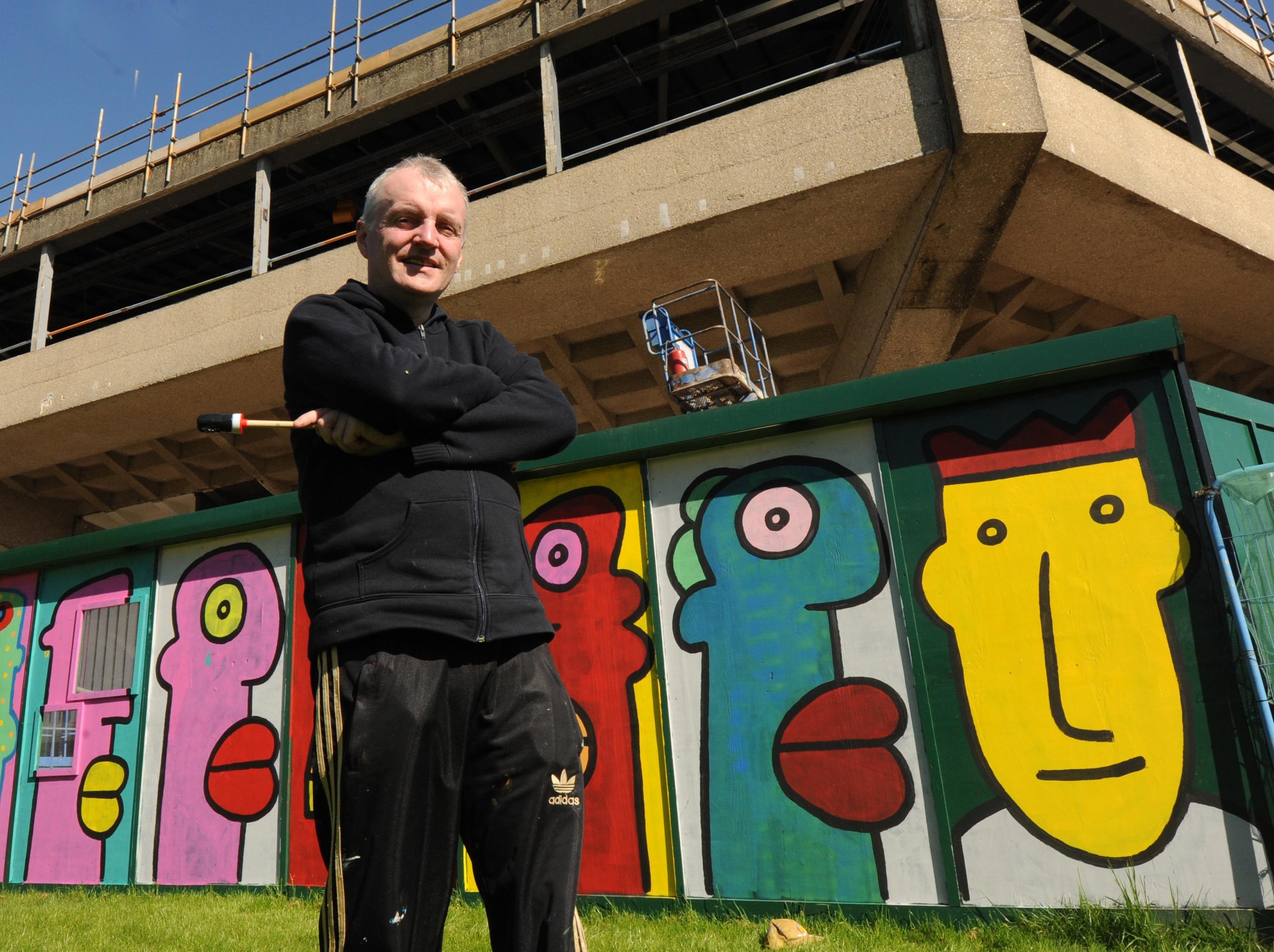 Thierry Noir pictured by his Chichester art work that surrounds the Festival Theatre.

Picture by Louise Adams C130629-17 Ent Street Art ENGSUS00120130705105415