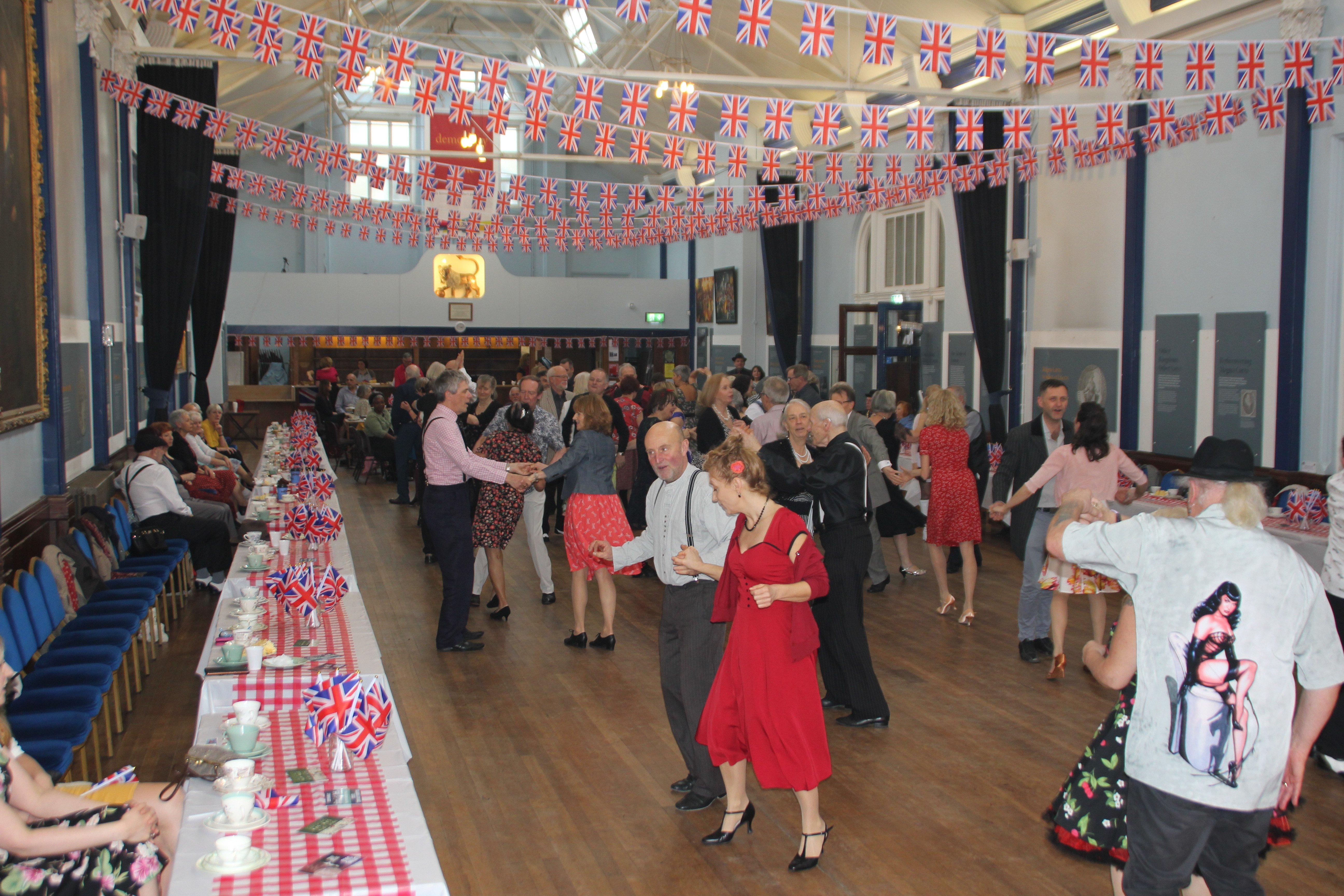 Couples dancing at a highly decorated Lewes Town Hall