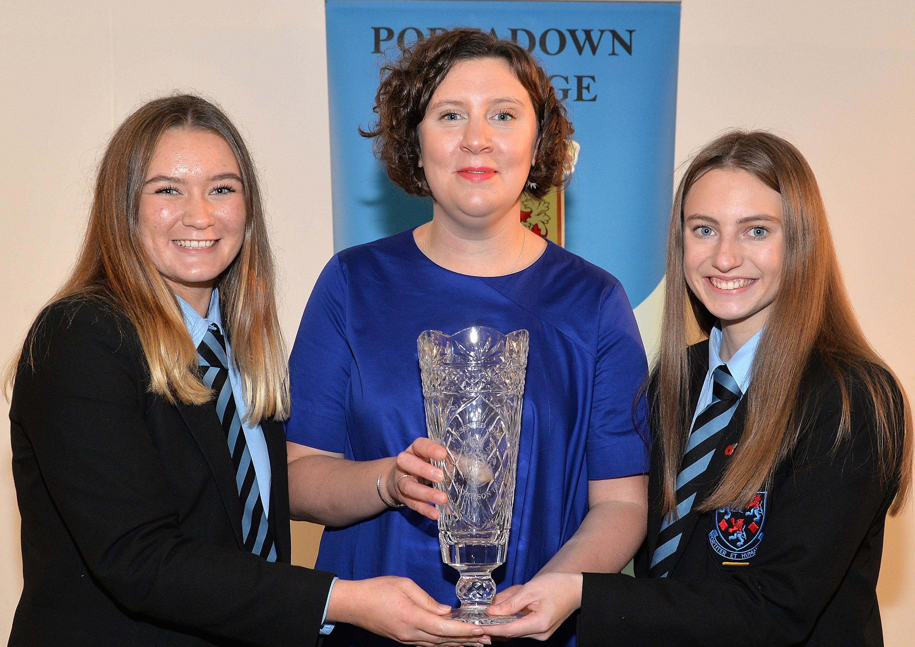 Portadown College pupils, Cassia Herron, left, and Ellen Wilson jointly receive the Nicholson Trophy for the best achievement at GCSE from special Guest, Shelley Brownlee at the school Speech Day. INPT44-215.