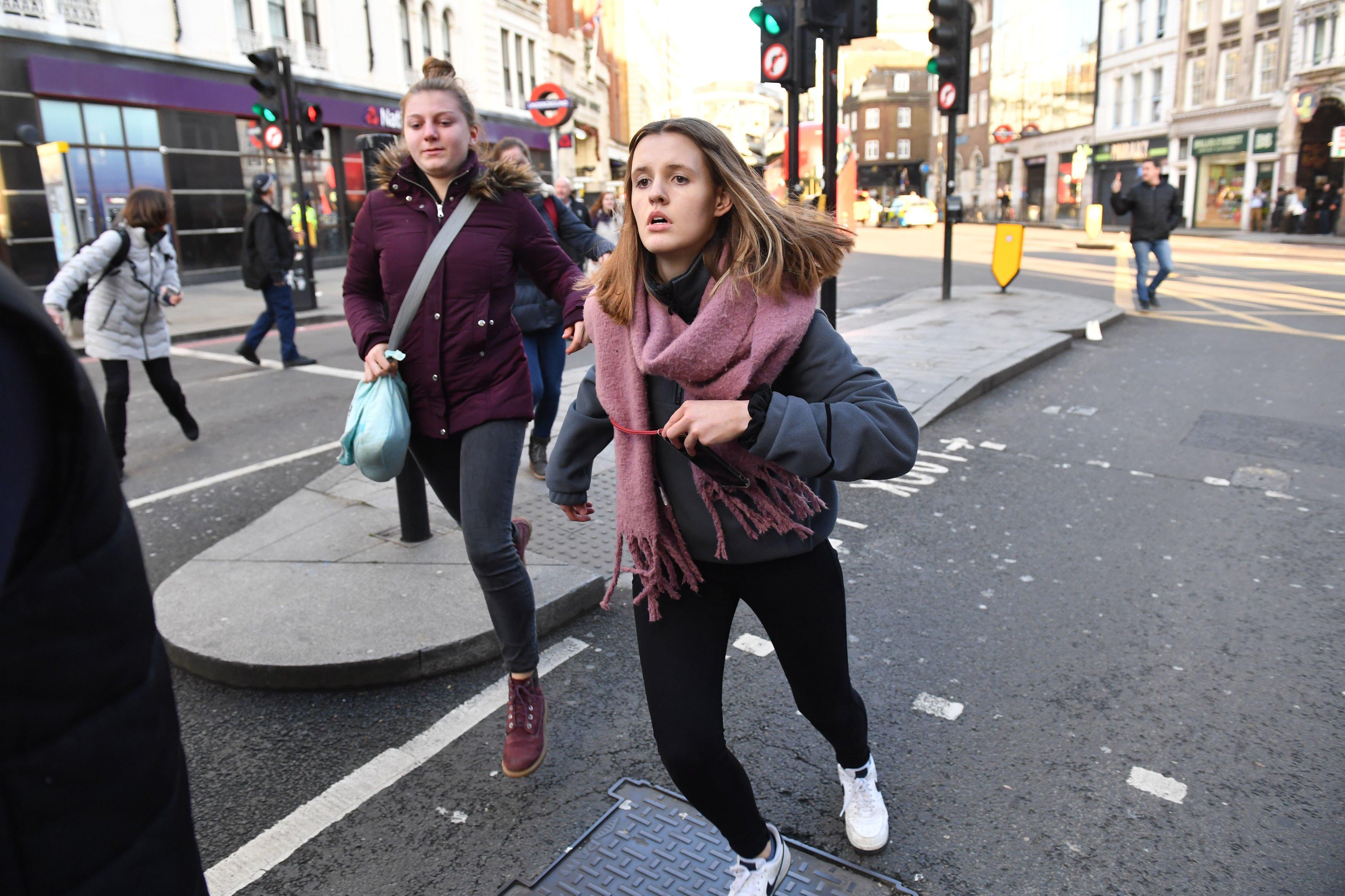 People fleeing from Borough Market, central London following a police incident. PA Photo