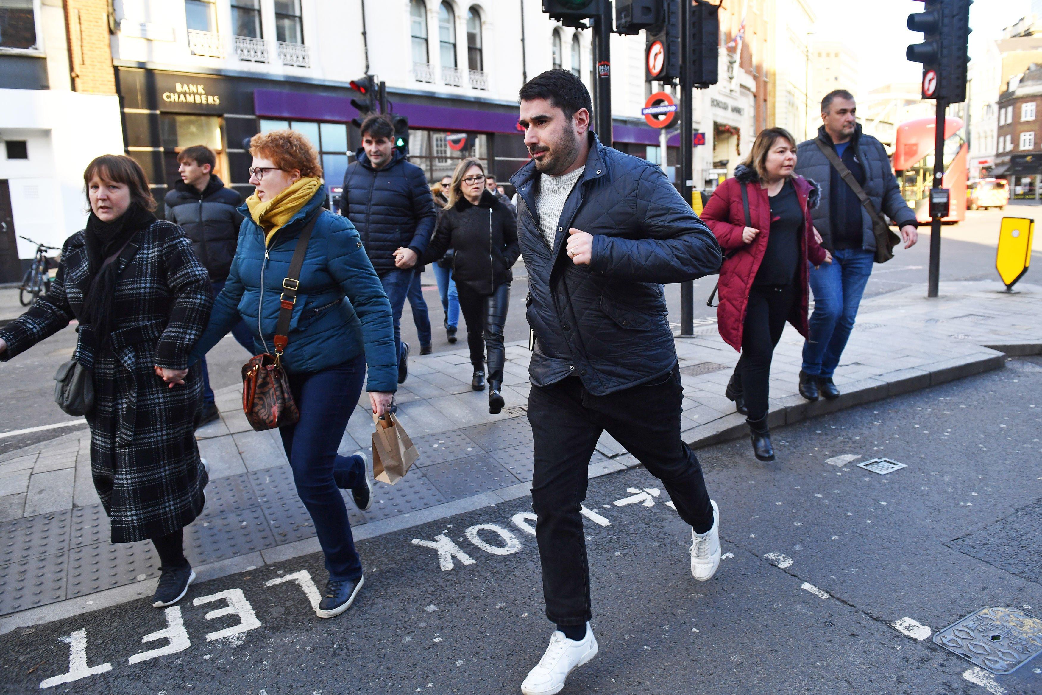 People running away from Borough Market in London after police told them to leave the area. PA Photo. Picture date: Friday November 29, 2019. See PA story POLICE LondonBridge. Photo credit should read: Dominic Lipinski/PA Wire