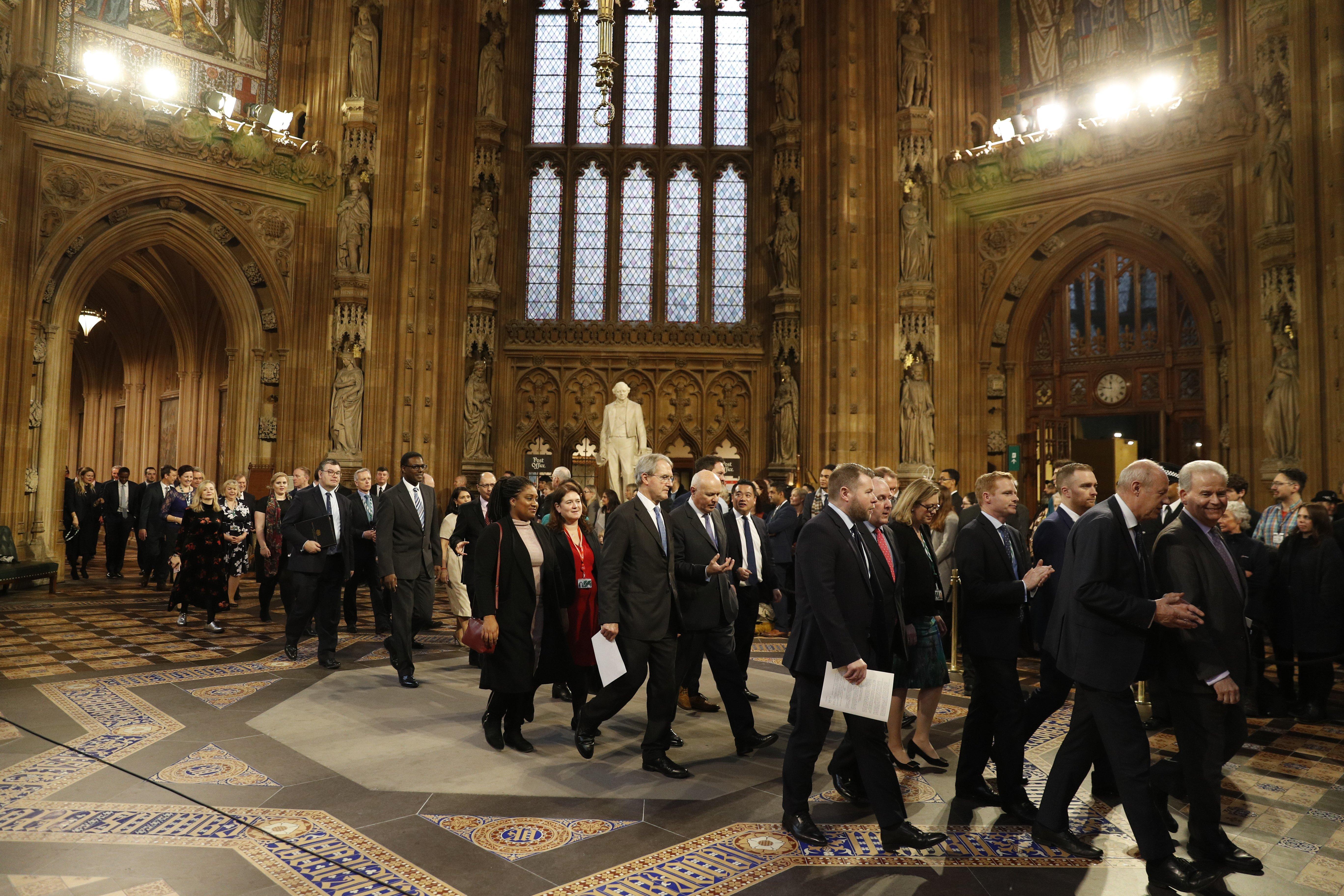 Members of Parliament process through the Central Lobby from the Lords chamber back to the House of Commons following the State Opening of Parliament by Queen Elizabeth II, in the House of Lords at the Palace of Westminster in London.