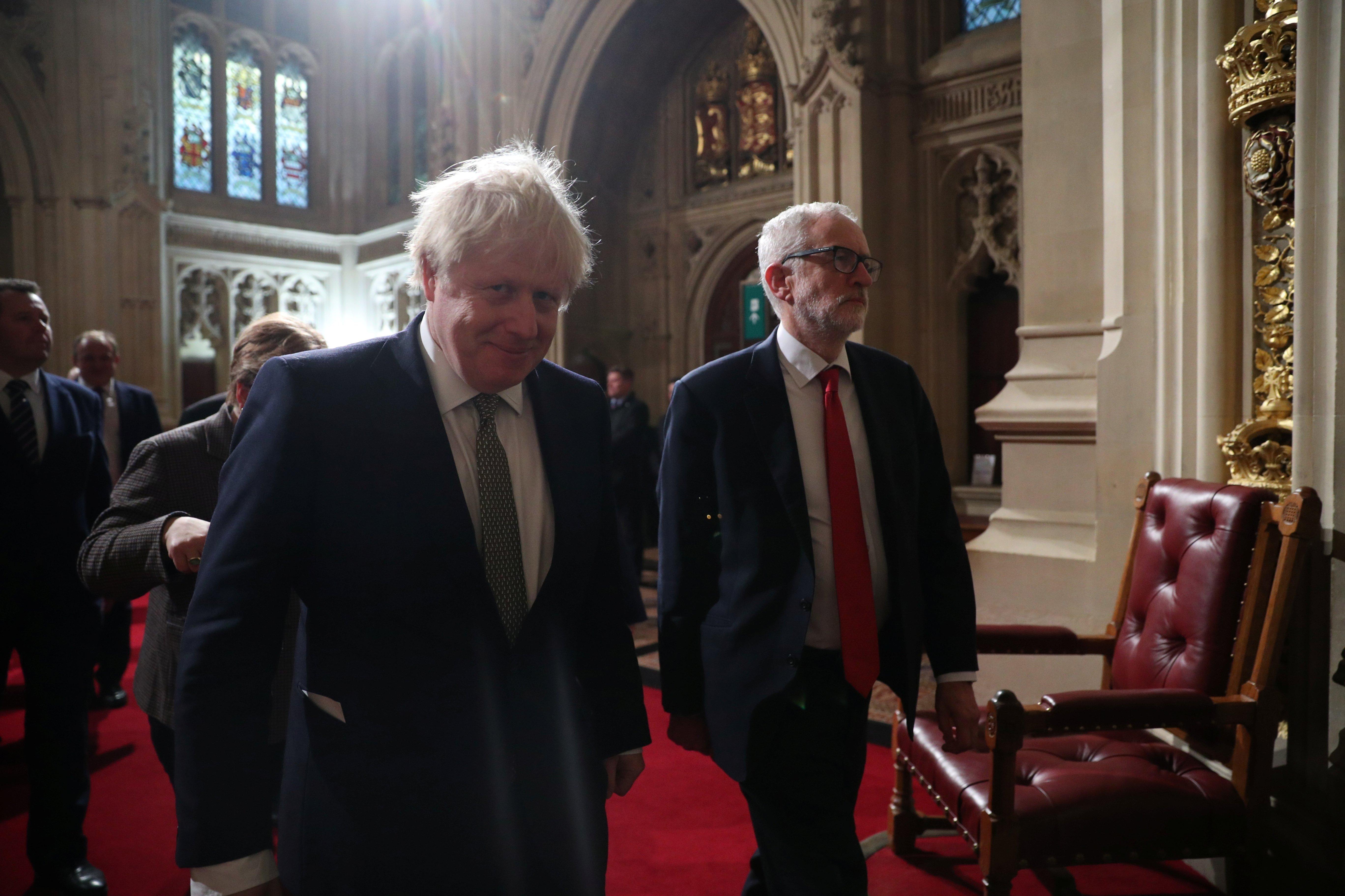 Prime Minister Boris Johnson and Labour Party leader Jeremy Corbyn walk through the Peers Lobby during the State Opening of Parliament by Queen Elizabeth II, in the House of Lords at the Palace of Westminster in London.