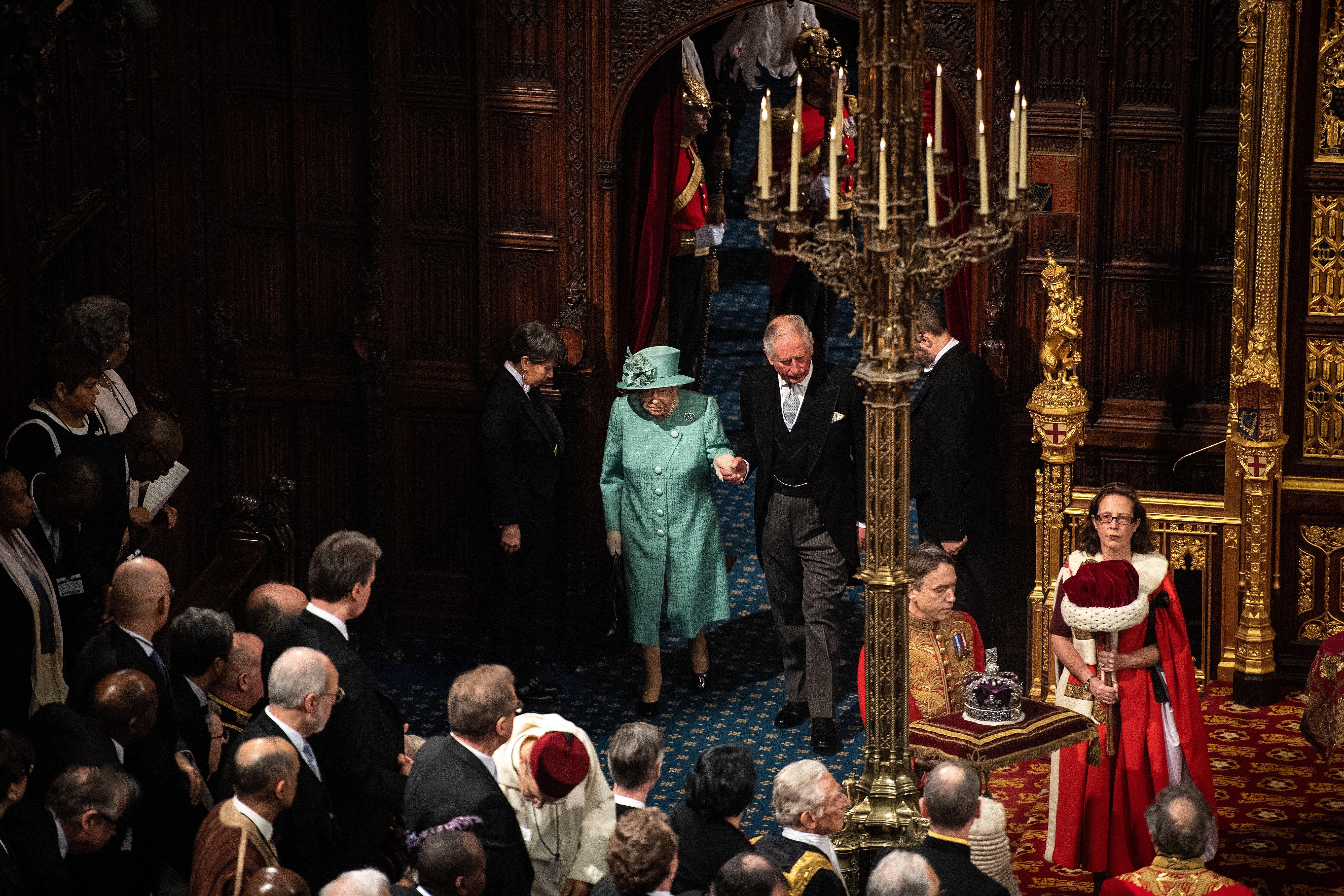 Queen Elizabeth II accompanied by Prince Charles, Prince of Wales, enters the chamber, during the State Opening of Parliament, in the House of Lords at the Palace of Westminster in London.