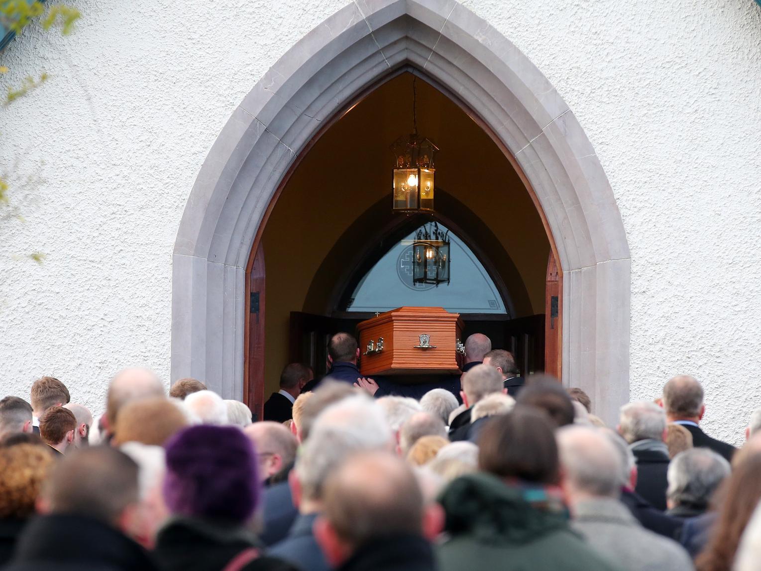 The coffin containing the remains of Seamus Mallon is carried into St James' of Jerusalem Church in Mullaghbrack, Co. Armagh.