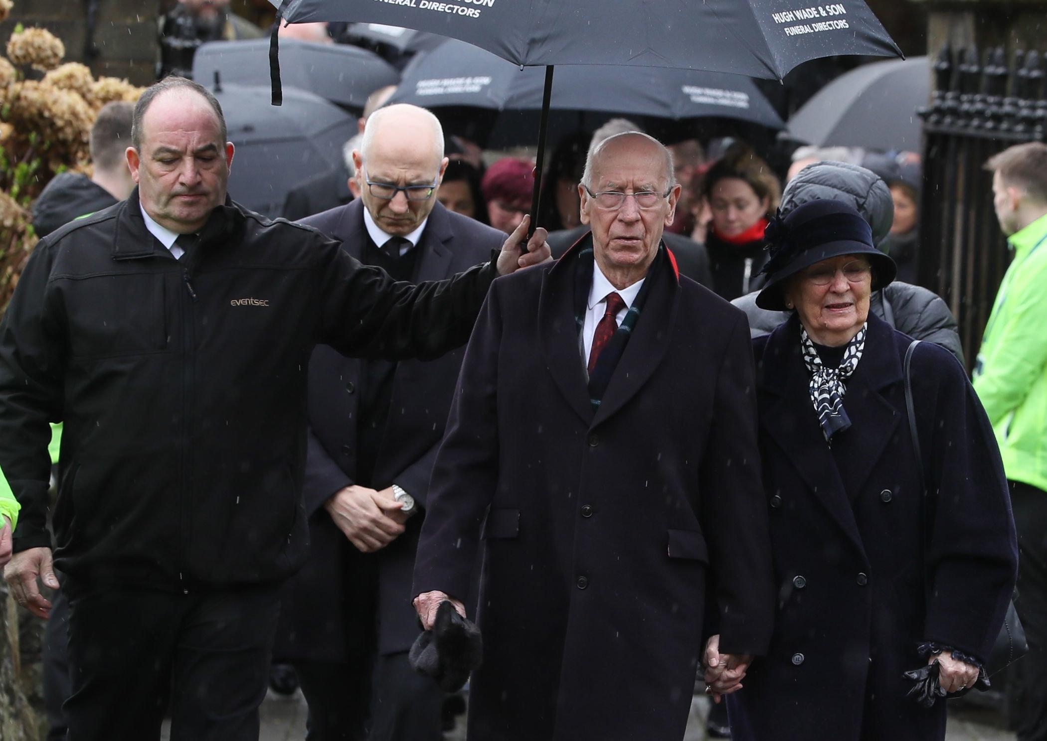 Sir Bobby Charlton and wife Norma arrive for the funeral of former Manchester United and Northern Ireland goalkeeper Harry Gregg, at St Patrick's Parsh Church, Coleraine